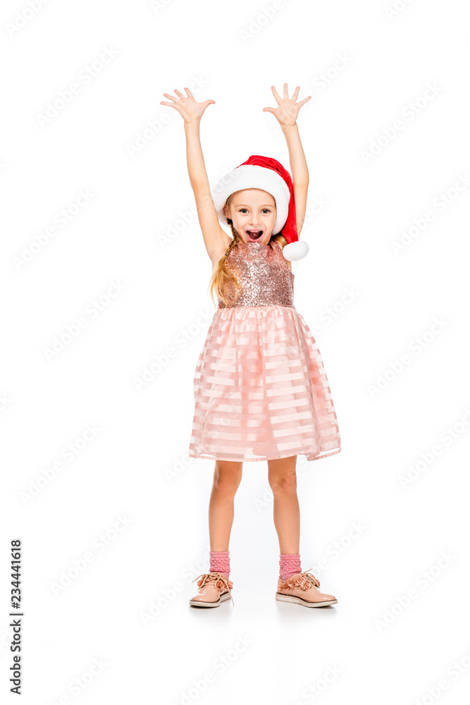 adorable little child in santa hat raising hands and celebrating isolated on white adorable little child in santa hat raising hands and celebrating isolated on white