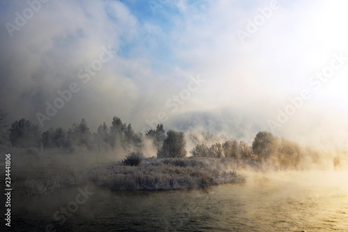 Beautiful winter landscape in Siberia. Winter landscape at the soaring river. Fog on the river in winter.