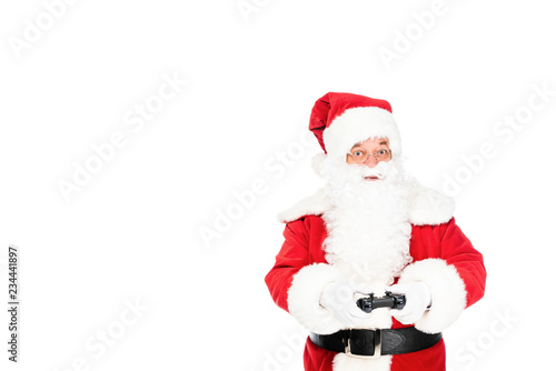 santa claus playing video game with gamepad and looking at camera isolated on white © LIGHTFIELD STUDIOS