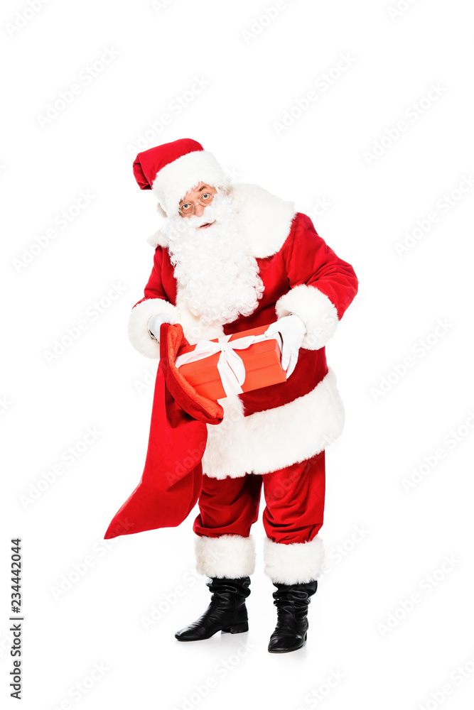 santa claus putting present into bag isolated on white santa claus putting present into bag isolated on white