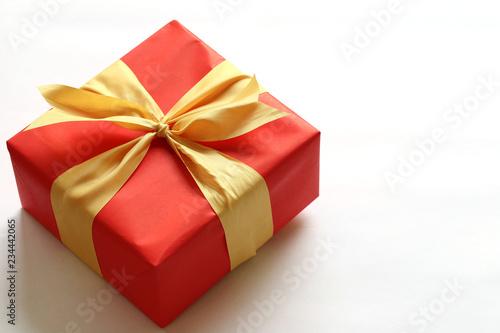 Red gift box isolated on white with close-up. © meepoohyaphoto