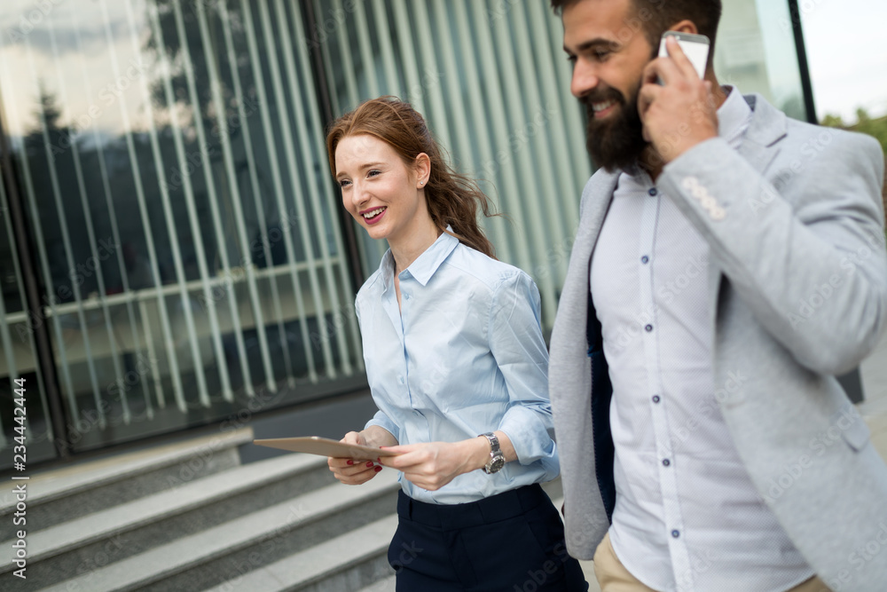 Young business couple walking outdoor near office building Young business couple walking outdoor near office building
