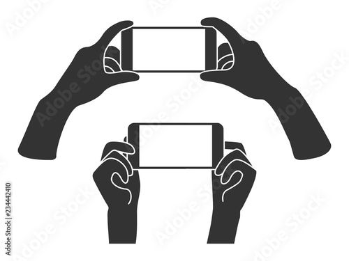 Hands holding phone in horizontal position. Blank screen mobile phone for message or photo.