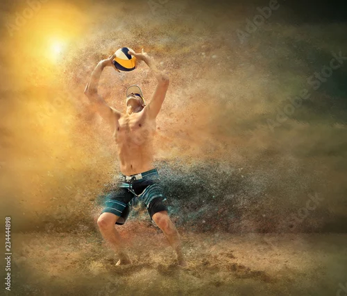 Obraz Plażowy siatkarz w akci przy słonecznym dniem pod niebieskim niebem.