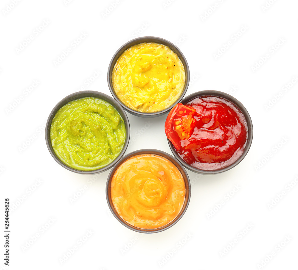 Different tasty sauces in bowls on white background Different tasty sauces in bowls on white background