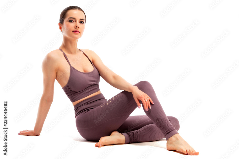 Fit sporty young woman posing on white background Fit sporty young woman posing on white background