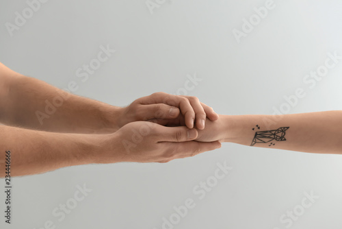 Man holding hand of woman o...