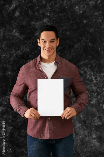 Young man with blank sheet ...