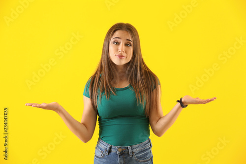 Fotografie Emotional young woman after making mistake on color background