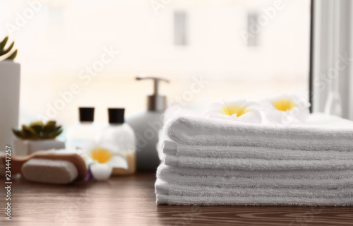 Fototapeta Naklejka Na Ścianę i Meble -  White terry towels on wooden table indoors