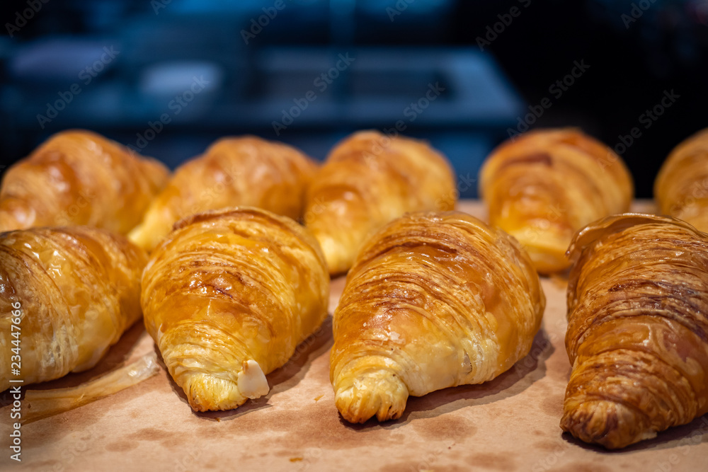 Assortment of delicious and buttery croissants made by pastry chef. All look very tasty and delightful. Natural light.