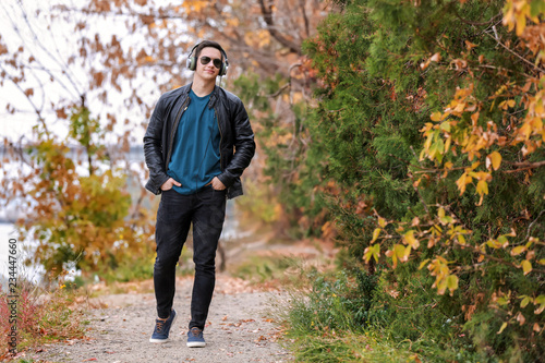 Young man listening to music in park