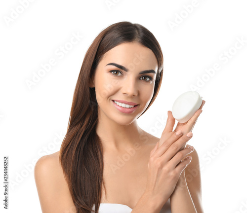 Beautiful young woman with soap on white background