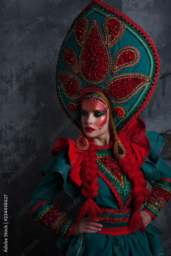 Girl in a headdress. beautiful young woman in a stylized Russian suit