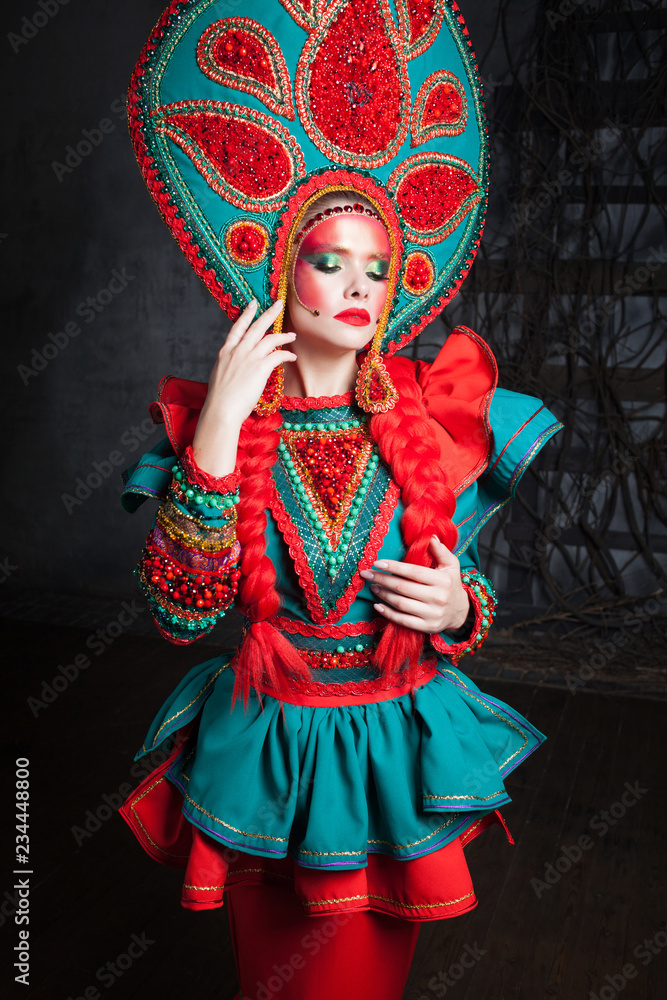 Girl in a headdress. beautiful young woman in a stylized Russian suit