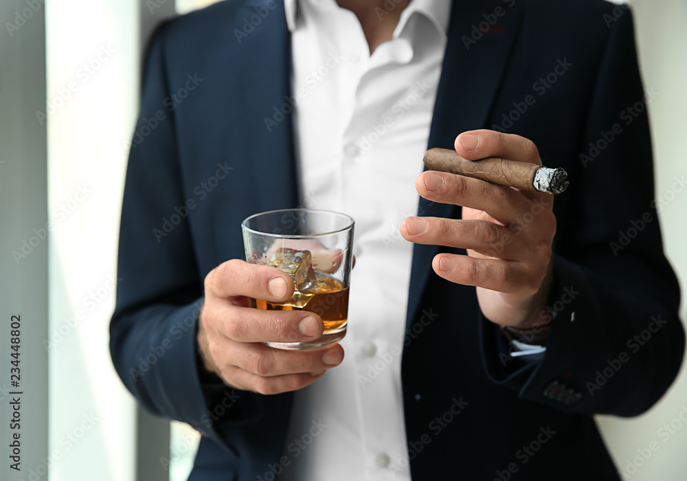 Senior man drinking whiskey and smoking cigar, closeup Senior man drinking whiskey and smoking cigar, closeup