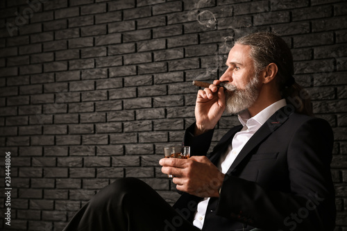 Senior man drinking whiskey...