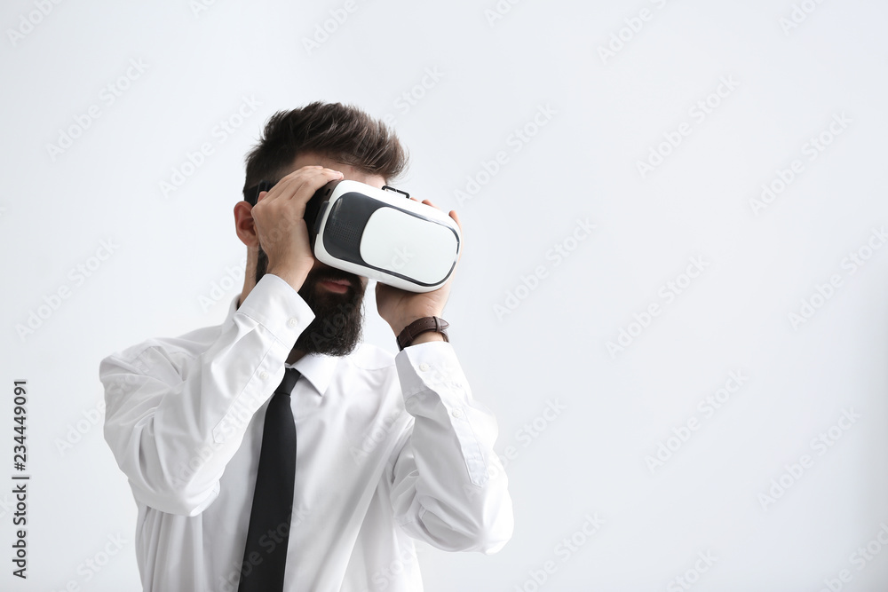 Businessman wearing virtual reality glasses on white background Businessman wearing virtual reality glasses on white background