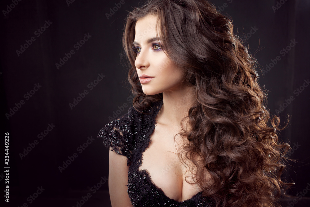 Portrait of a young attractive woman with gorgeous curly hair. Attractive brunette. Portrait of a young attractive woman with gorgeous curly hair. Attractive brunette.