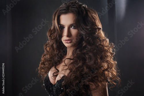 Portrait of a young attractive woman with gorgeous curly hair. Attractive brunette.
