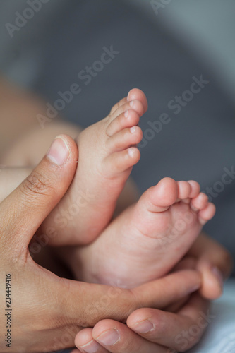 Close up of newborn baby feet. Baby's feet in the mother hands. Baby. Cozy. Love. Family.
