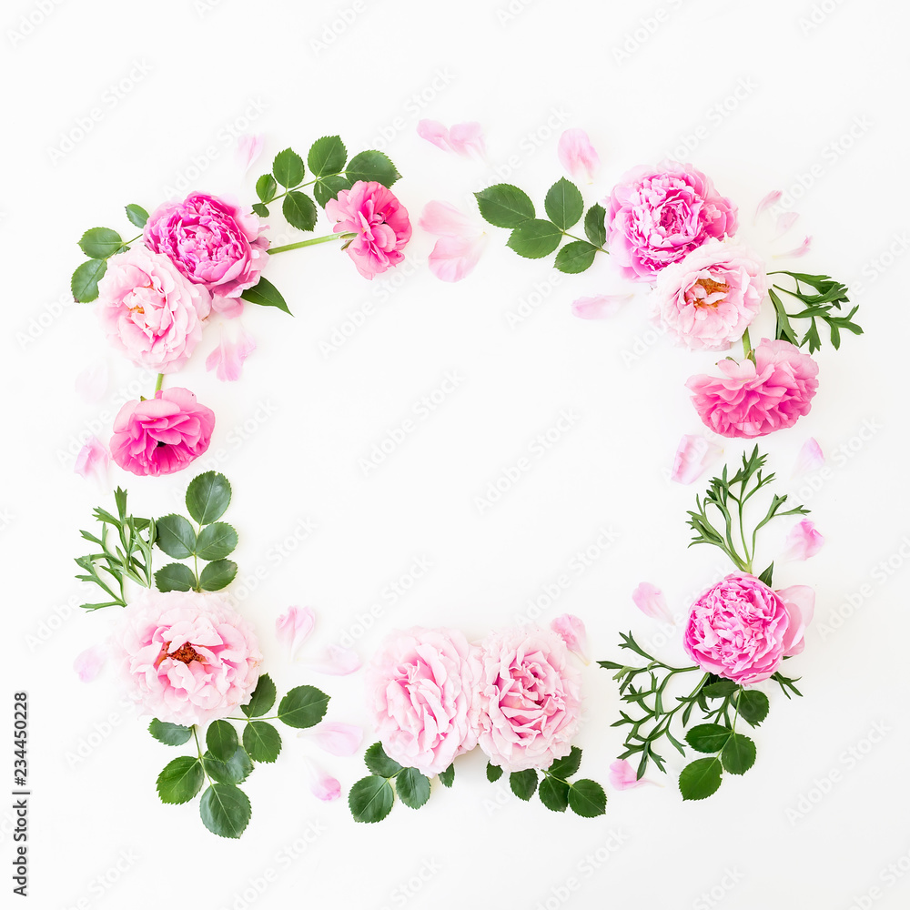 Floral frame of pastel pink roses, peonies and green leaves on white background. Flat lay, top view. Spring time composition