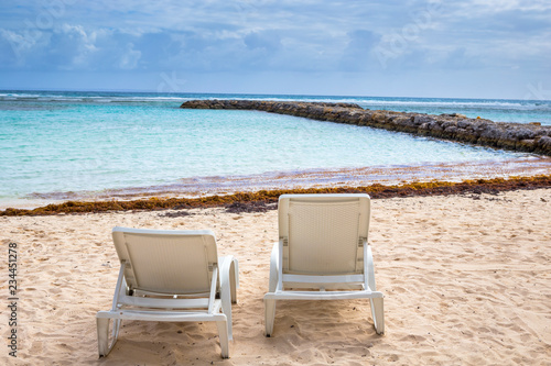 Fototapeta Naklejka Na Ścianę i Meble -  White chairs at beach in Guadeloupe