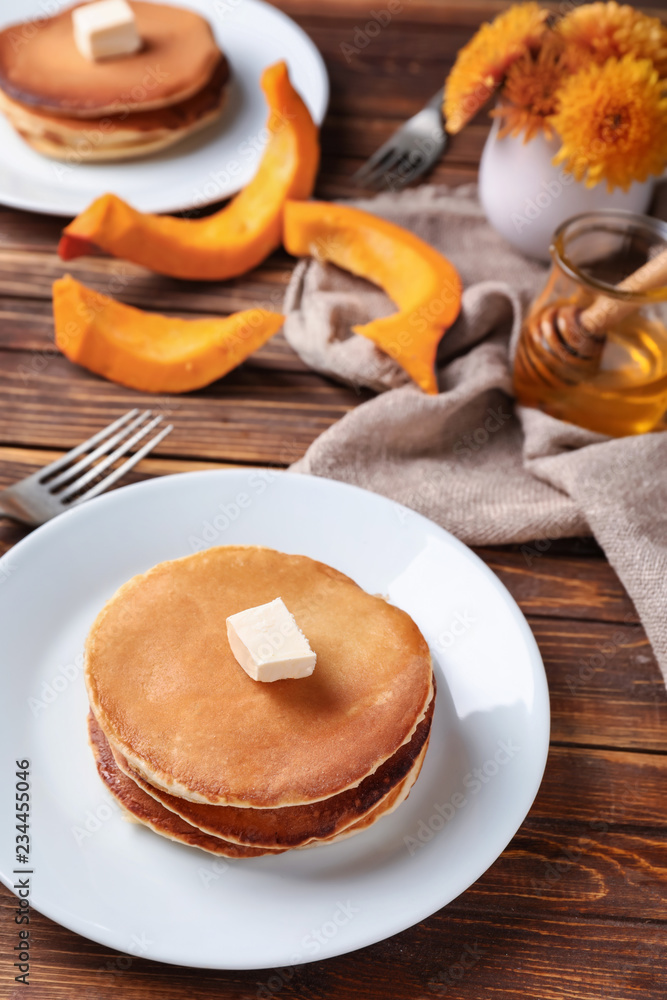 Stack of hot pumpkin pancakes with butter on plate Stack of hot pumpkin pancakes with butter on plate