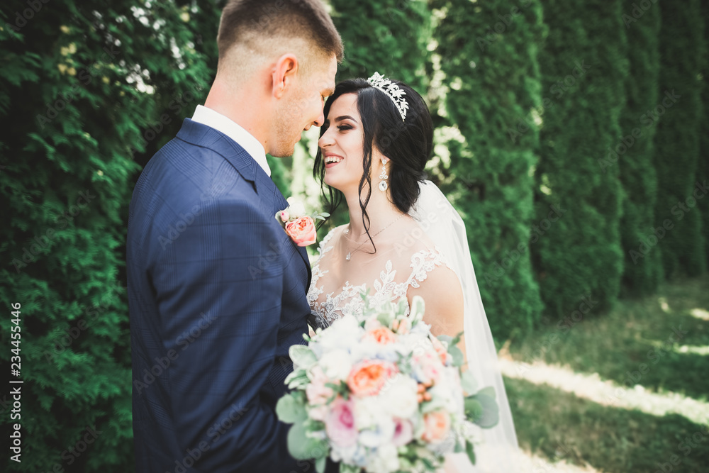 Beautiful romantic wedding couple of newlyweds hugging in park Beautiful romantic wedding couple of newlyweds hugging in park