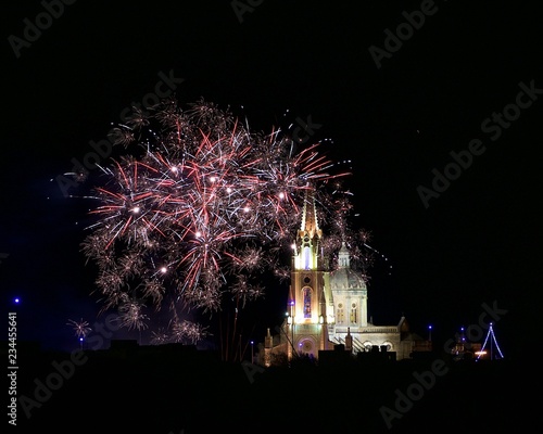 Fireworks background. Colorful fireworks. Colorful explosion in little village in Malta with the illuminate Parish church in the background, august feast in Malta