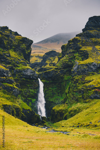 Majestic waterfall Seljalandsfoss in Iceland in autumn in cloudy weather