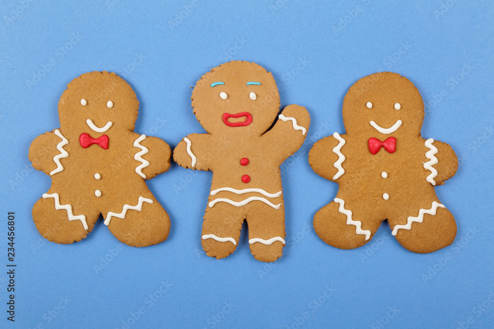 Christmas cookies, gingerbread In the form of a man on blue background. Christmas background Christmas cookies, gingerbread In the form of a man on blue background. Christmas background