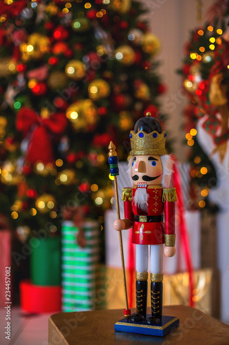 New Year s scenery. The figure of the Nutcracker on the background of Christmas lights