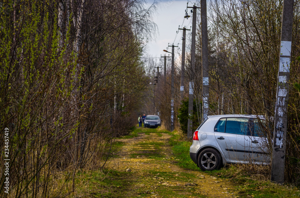 Countryside road with parked cars along Countryside road with parked cars along