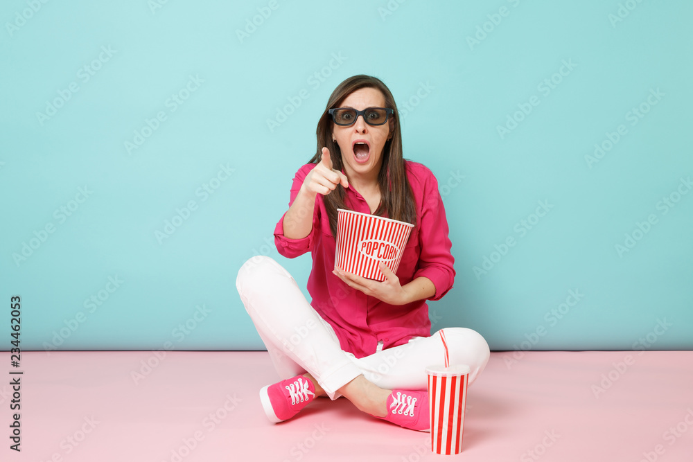 Full length portrait fun woman in rose shirt, white pants sitting on floor watching movie film isolated on bright pink blue pastel wall background studio. Fashion lifestyle concept. Mock up copy space Full length portrait fun woman in rose shirt, white pants sitting on floor watching movie film isolated on bright pink blue pastel wall background studio. Fashion lifestyle concept. Mock up copy space
