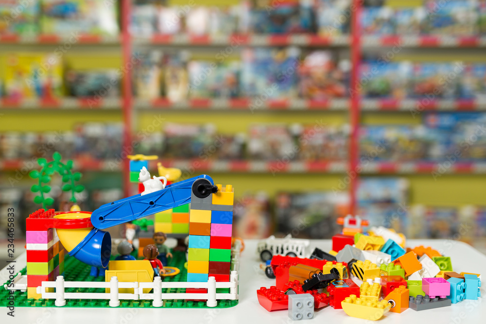 Fototapeta premium Plastic toy blocks on the white table in the store.