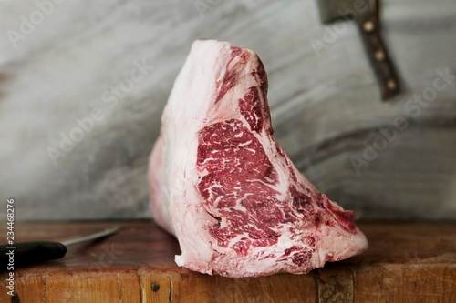 A Bone-In New York Strip Loin on a Rustic Butcher Block photo