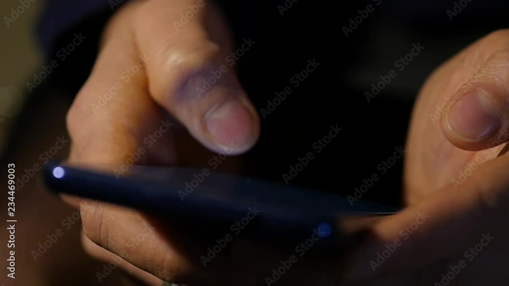 close up women's fingers are using smartphone in the night. girl browsing internet on a mobile phone. slow motion close up women's fingers are using smartphone in the night. girl browsing internet on a mobile phone. slow motion