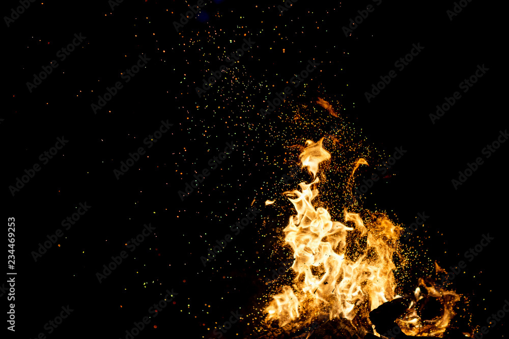 Burning woods with firesparks, flame and smoke. Strange weird odd elemental fiery figures on black background. Coal and ash. Abstract shapes at night. Bonfire outdoor on nature. Strenght of element. Burning woods with firesparks, flame and smoke. Strange weird odd elemental fiery figures on black background. Coal and ash. Abstract shapes at night. Bonfire outdoor on nature. Strenght of element.