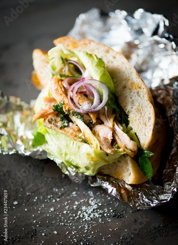 Chicken donner with lettuce and onions as a takeaway photo