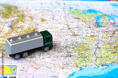 Miniature truck on a road map. Concept for visualization of delivery services, logistics, forwarding. With place for logo and text