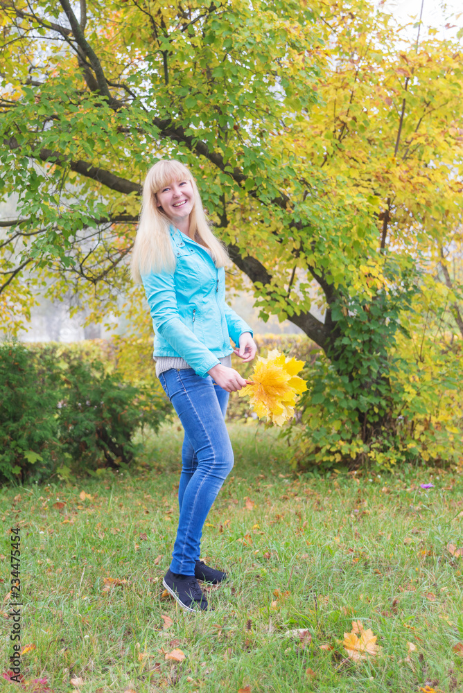 Blond girl  in the autumn park