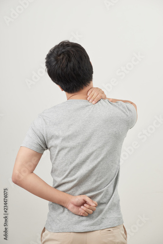 Man rubbing his painful back close up. Business man holding his lower back. Pain relief, chiropractic concept