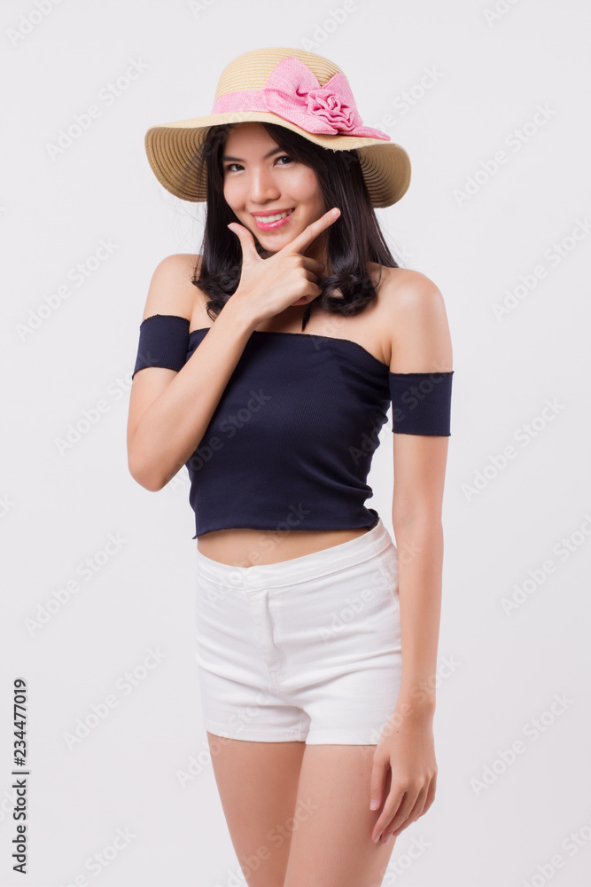 happy smiling woman wearing summer travel hat. portrait of positive optimistic woman traveller, studio white isolated with holiday or vacation concept. young adult beautiful girl asian woman model happy smiling woman wearing summer travel hat. portrait of positive optimistic woman traveller, studio white isolated with holiday or vacation concept. young adult beautiful girl asian woman model