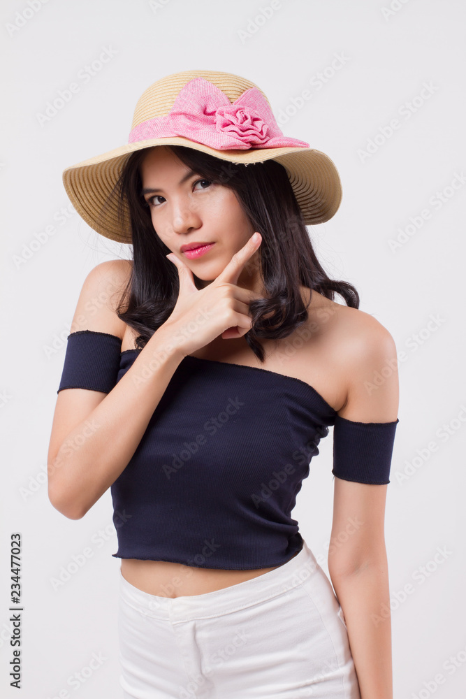 happy confident woman wearing summer travel hat. portrait of positive optimistic woman traveller, studio white isolated with holiday or vacation concept. young adult beautiful girl asian woman model happy confident woman wearing summer travel hat. portrait of positive optimistic woman traveller, studio white isolated with holiday or vacation concept. young adult beautiful girl asian woman model