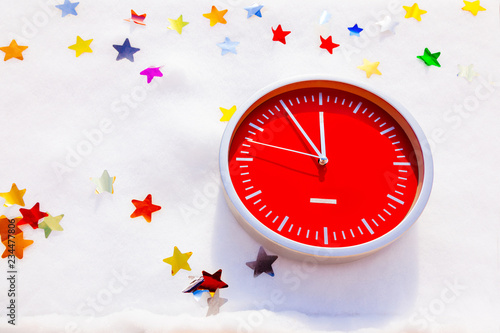 Red wall clock isolated white background snow new year postcard stars shine white time twelve horologe