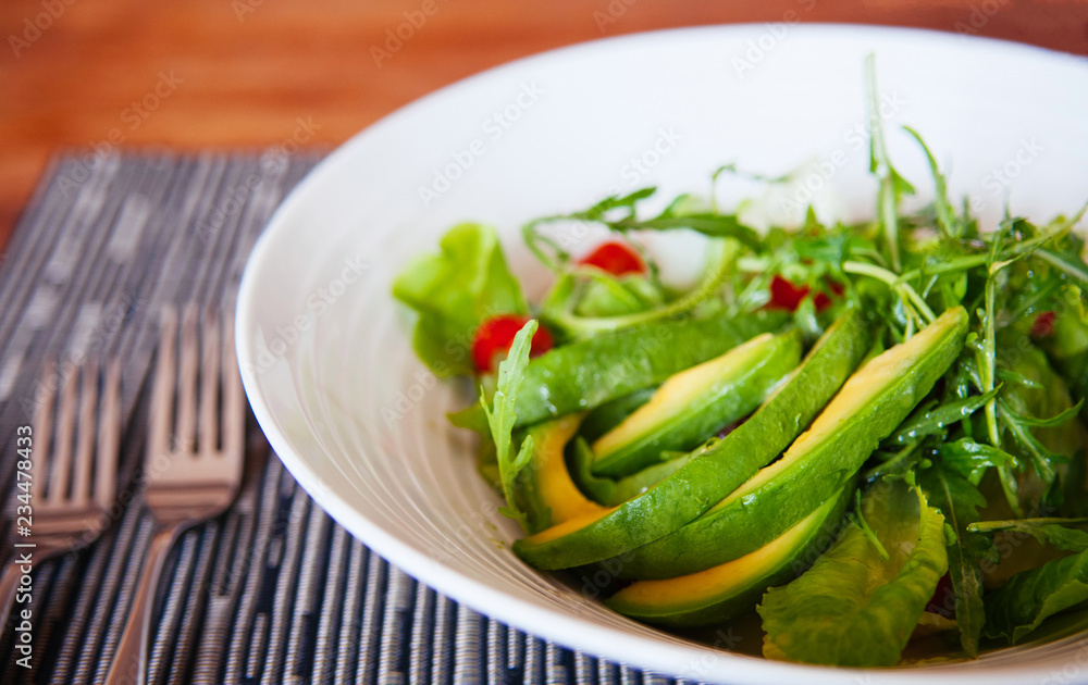 Avocado Arugula and cherry tomatoes salad with light dressing Avocado Arugula and cherry tomatoes salad with light dressing
