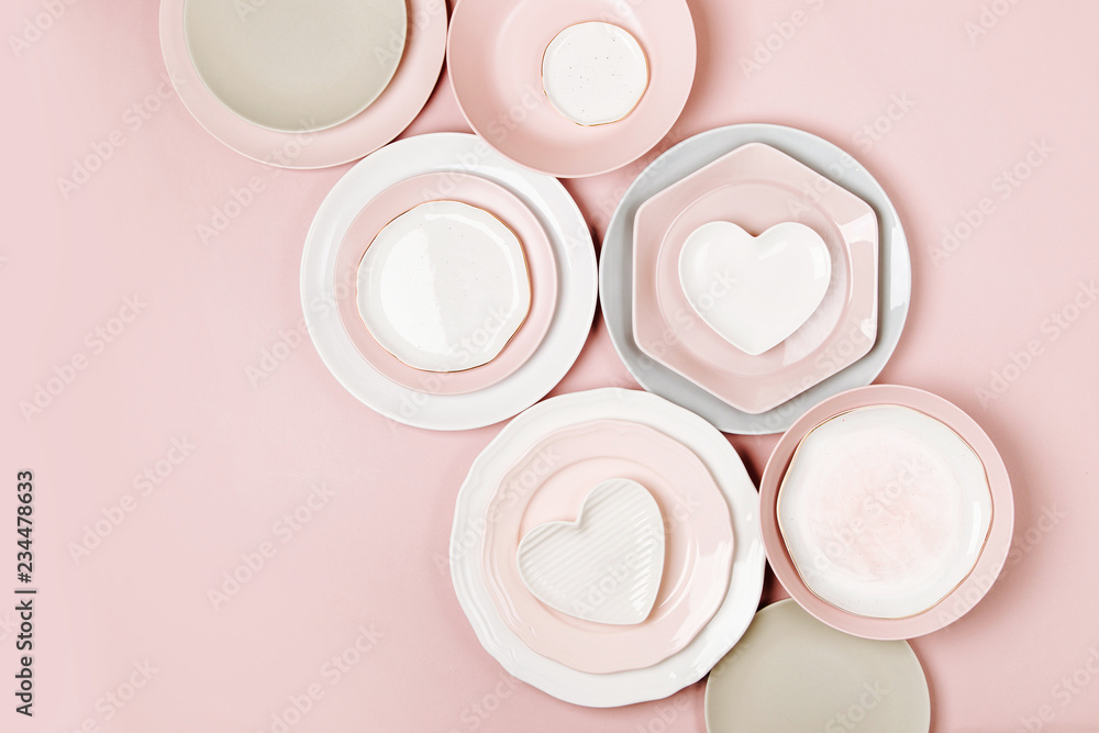 Plates and dishes for serving a festive table on pastel colors background. Flat lay, top view. Plates and dishes for serving a festive table on pastel colors background. Flat lay, top view.