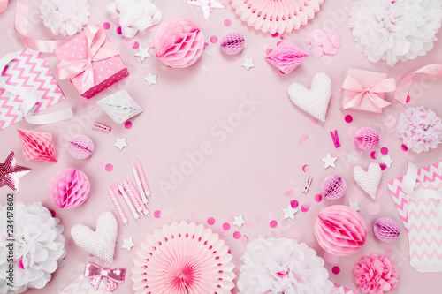 Frame made of Pink and white Paper Decorations, candy, hearts, gifts, confetti for Baby party. Flat lay, top view