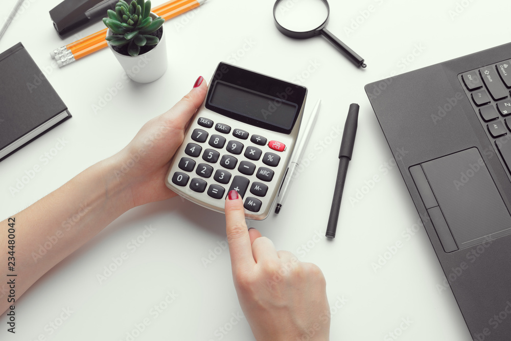 Business woman working with financial data hand using calculator